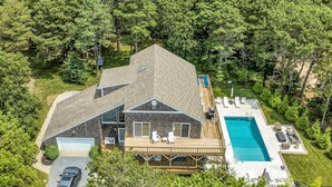 A large house with a deck and a swimming pool.