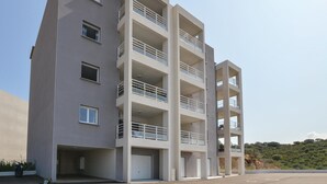 A multi-story residential building with balconies, a garage, and a parking area. - 1 bedroom gorgeous apartment in Ajaccio (Ajaccio)