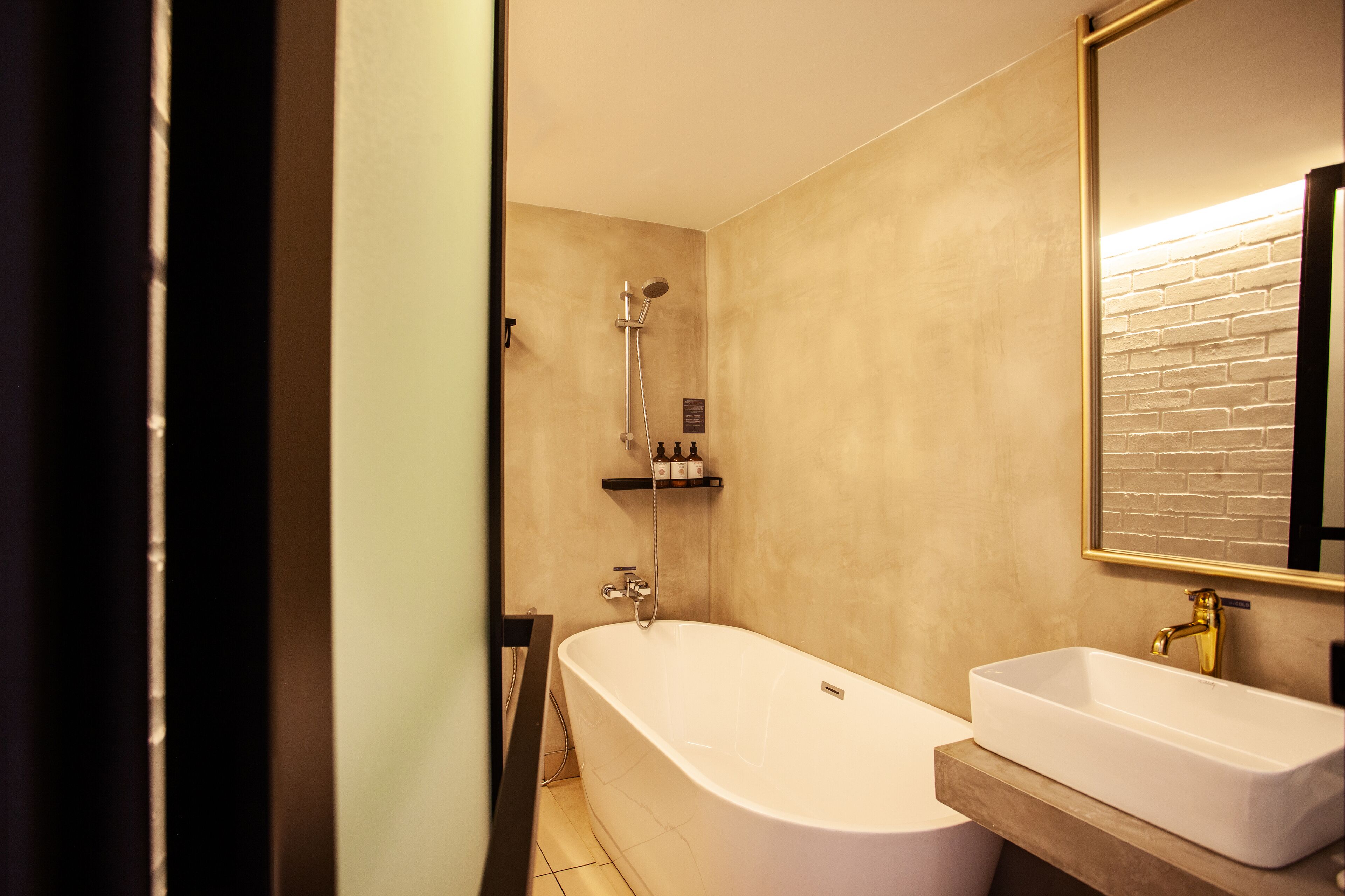 Un bagno moderno con una vasca freestanding, un mobile lavabo e uno specchio grande.