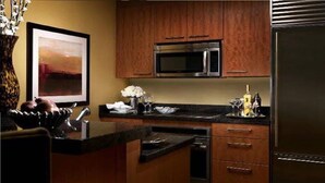 A modern kitchen with wooden cabinets, a stainless steel microwave, and a built-in dishwasher. - 2. 2 miles to convention center (Las Vegas)