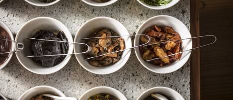 A top-down view of various dishes in bowls on a kitchen counter.