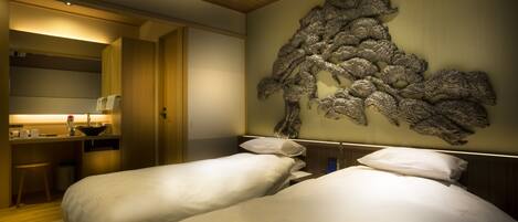 A hotel room with two beds, a desk with a chair, and a decorative wall piece.