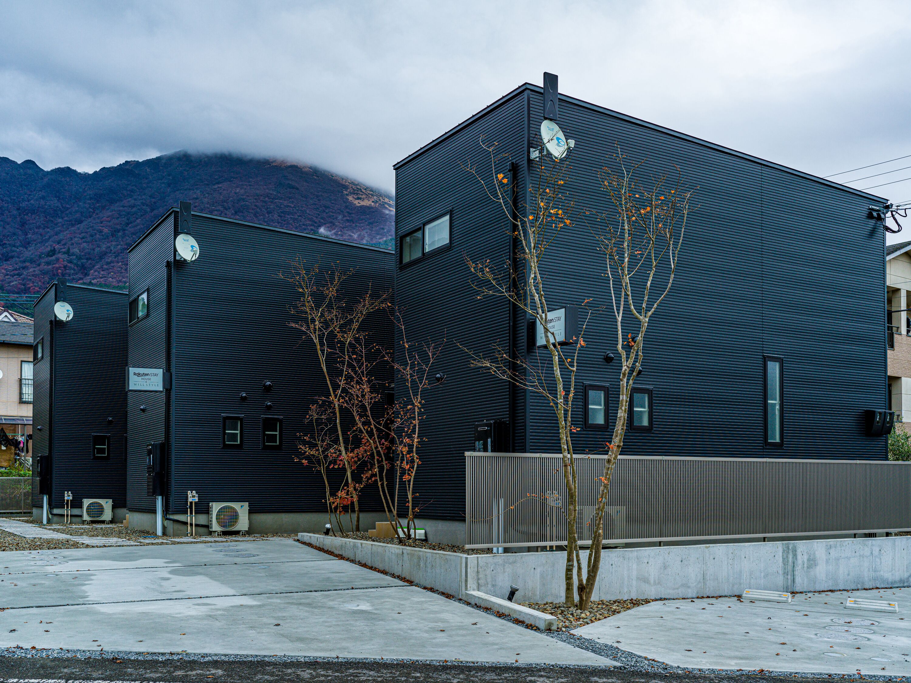 A modern building with a flat roof and a sign indicating it's a Robuten Stay House.