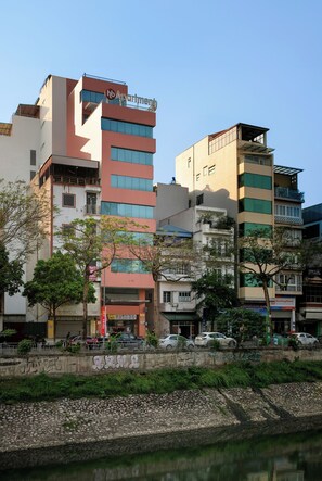 A multi-story building with a sign reading "nb Apartment".