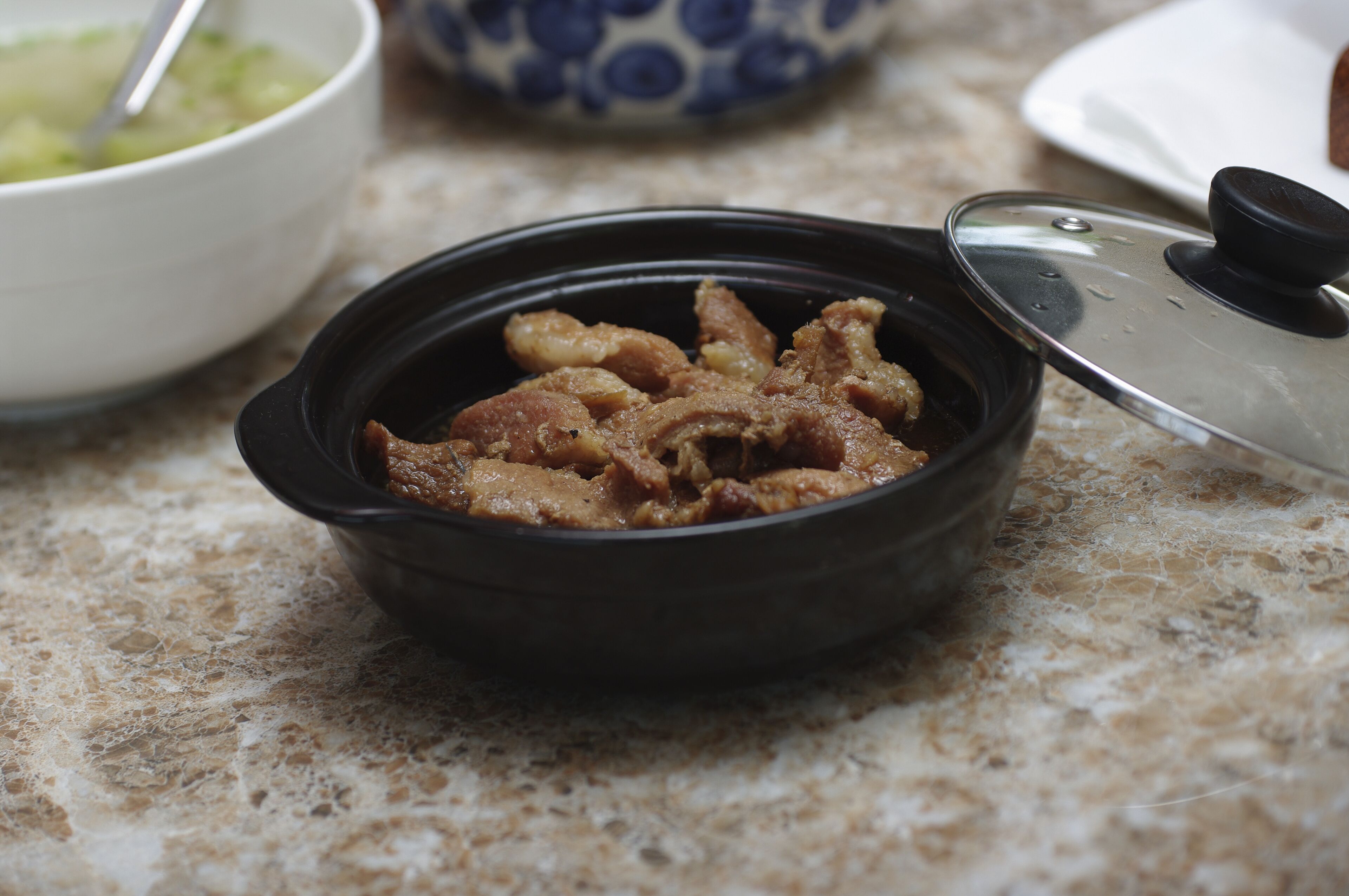 A black pot with a lid on a kitchen counter.