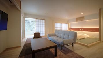 A modern living room with a sofa, a table, and a bed.