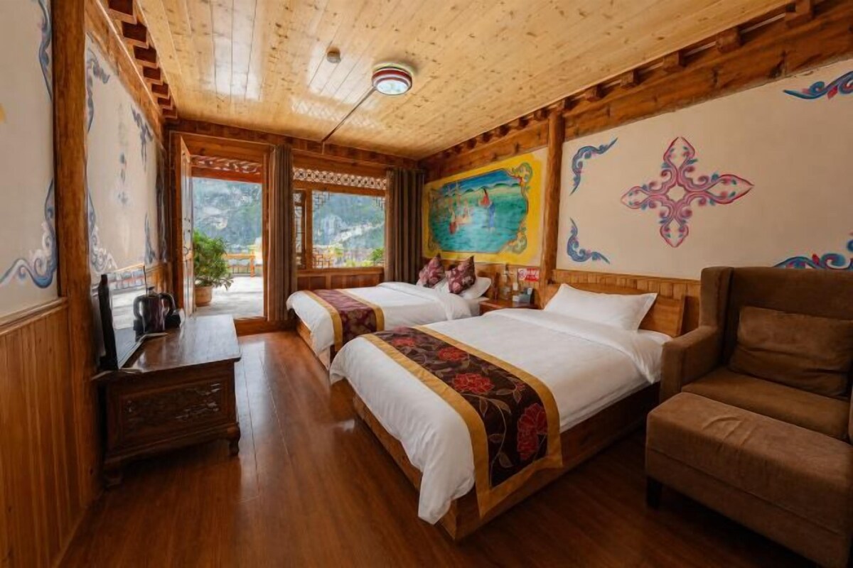A traditional room with two beds, a wooden ceiling, and a mural on the wall.