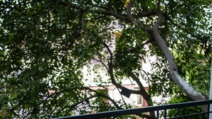 A balcony with a wooden table, a chair, and a magazine. - Purple Cloud Urban (Bengaluru)