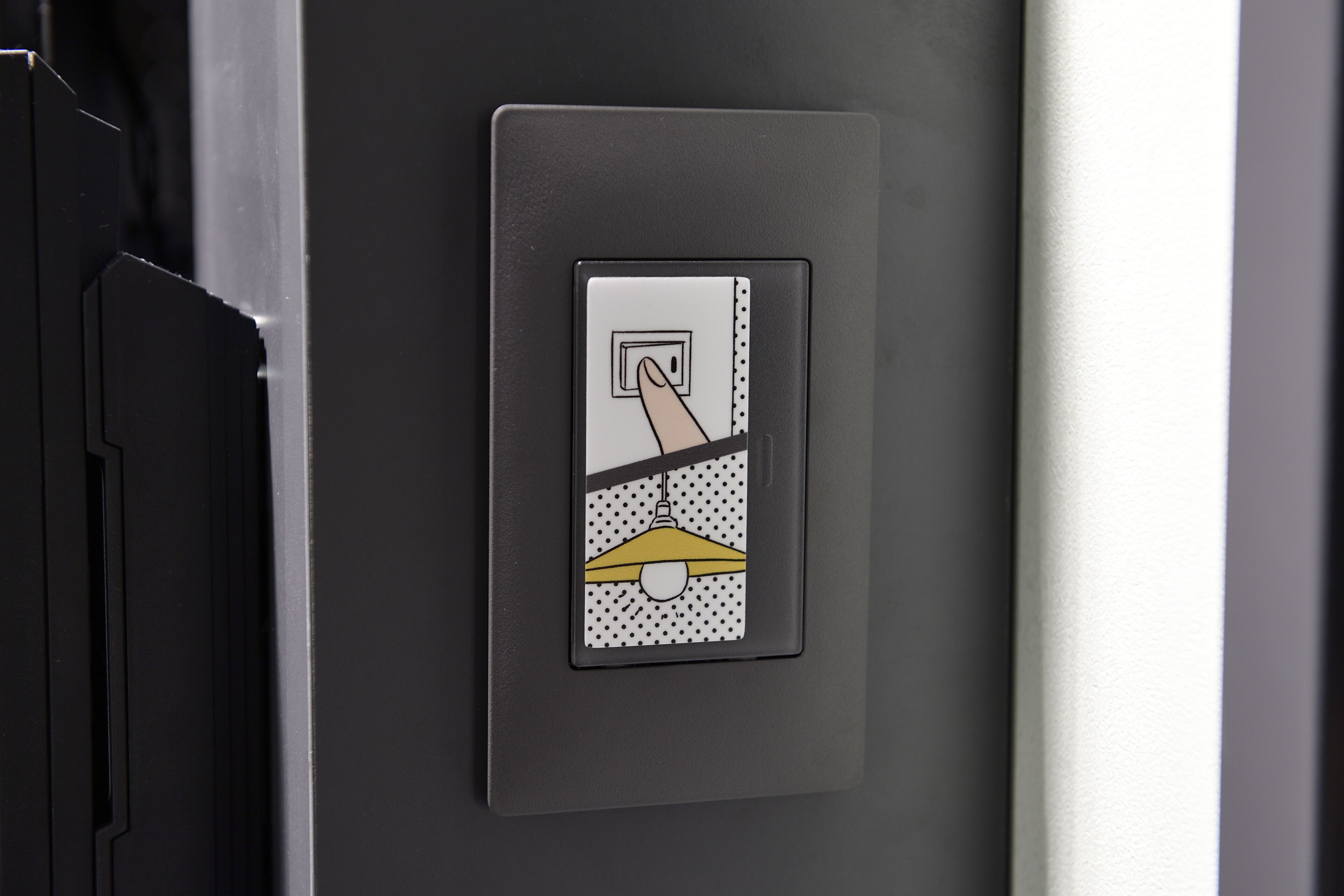 A control panel with a hand pressing a button, indicating an operational feature.