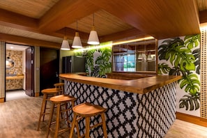 Enjoy cooking in this well-equipped kitchen with a large window offering a view of lush greenery.