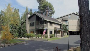 A two-story building with a balcony, a flag, and a sign that reads "Chesapeake." - Crestview 55: Pet Friendly, Close to The Village (Mammoth Lakes)