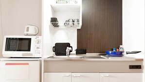 A compact kitchenette with a microwave, coffee maker, and a sink with a dish rack. - Apartment Y Legendoal Nipponbashi (Osaka)