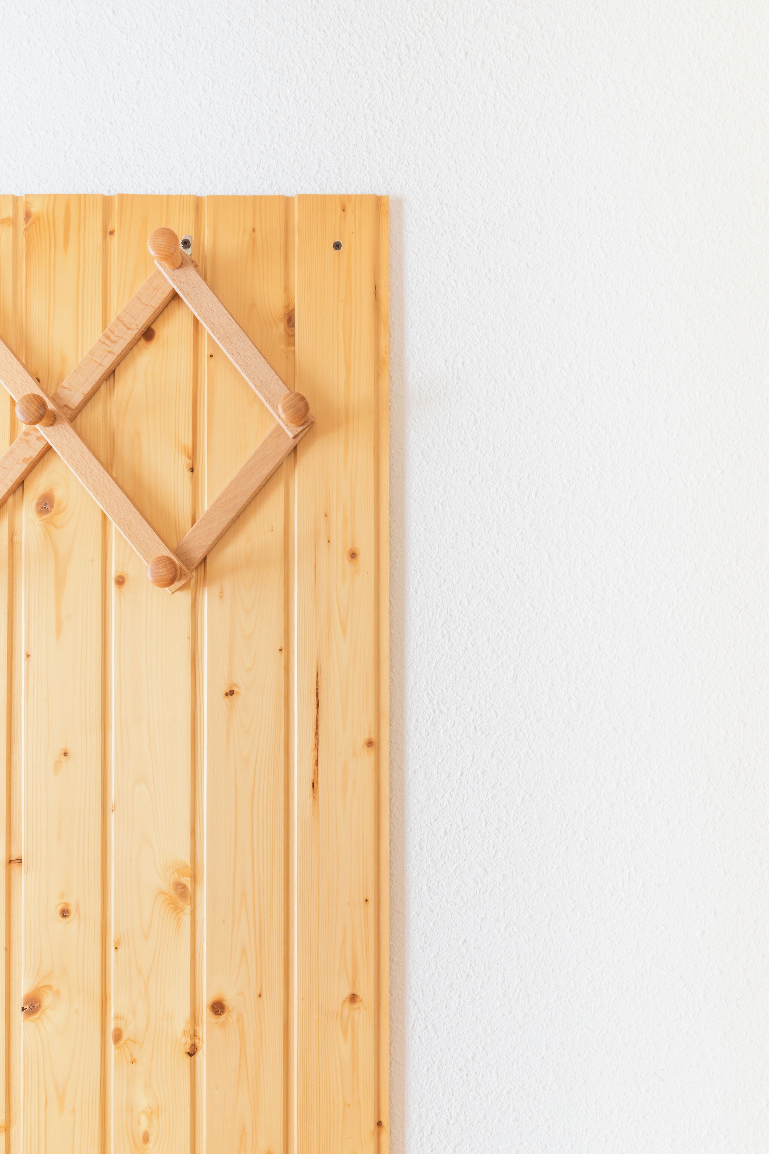 A wooden panel wall with a geometric wooden structure.