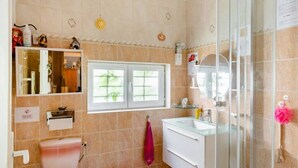 A bathroom with a toilet, sink, and shower. There is a window above the toilet, and a towel hanging on the wall. - Room In A House Full Of Life (Saint-Rémy-lès-Chevreuse)