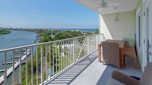 A balcony with a view of a marina and water.