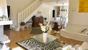 A spacious living room with a staircase, a glass coffee table, and a zebra-patterned rug. - Villa with swimming pool, 10 mn from Montpellier, 20 mn from the beaches (Pignan)