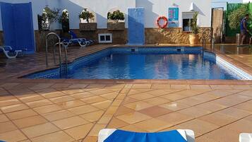 Seasonal outdoor pool, open 9:00 AM to 9:00 PM, pool umbrellas