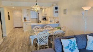 A compact living space with a dining area, kitchenette, and seating area.