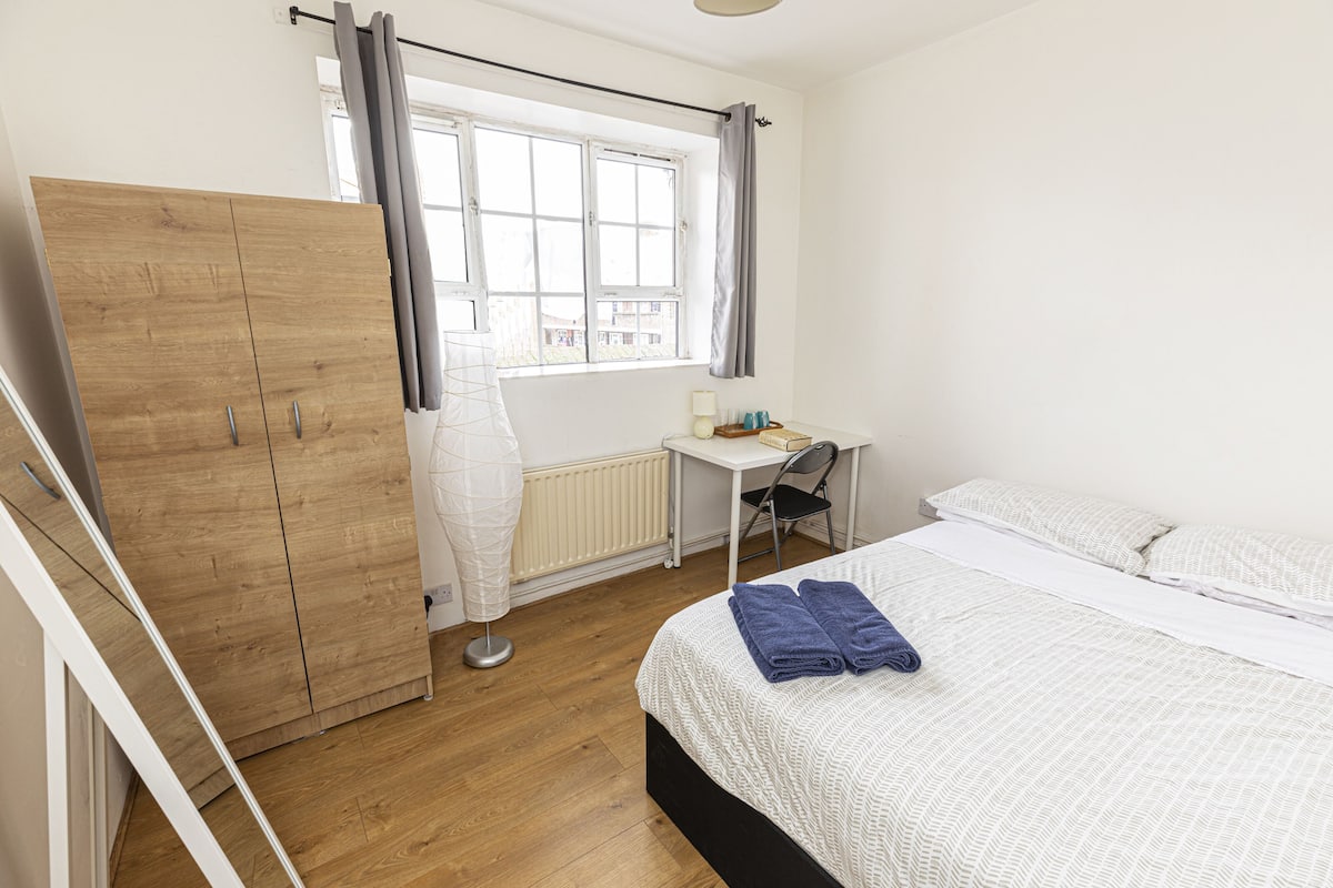 Desk, laptop workspace, iron/ironing board, bed sheets