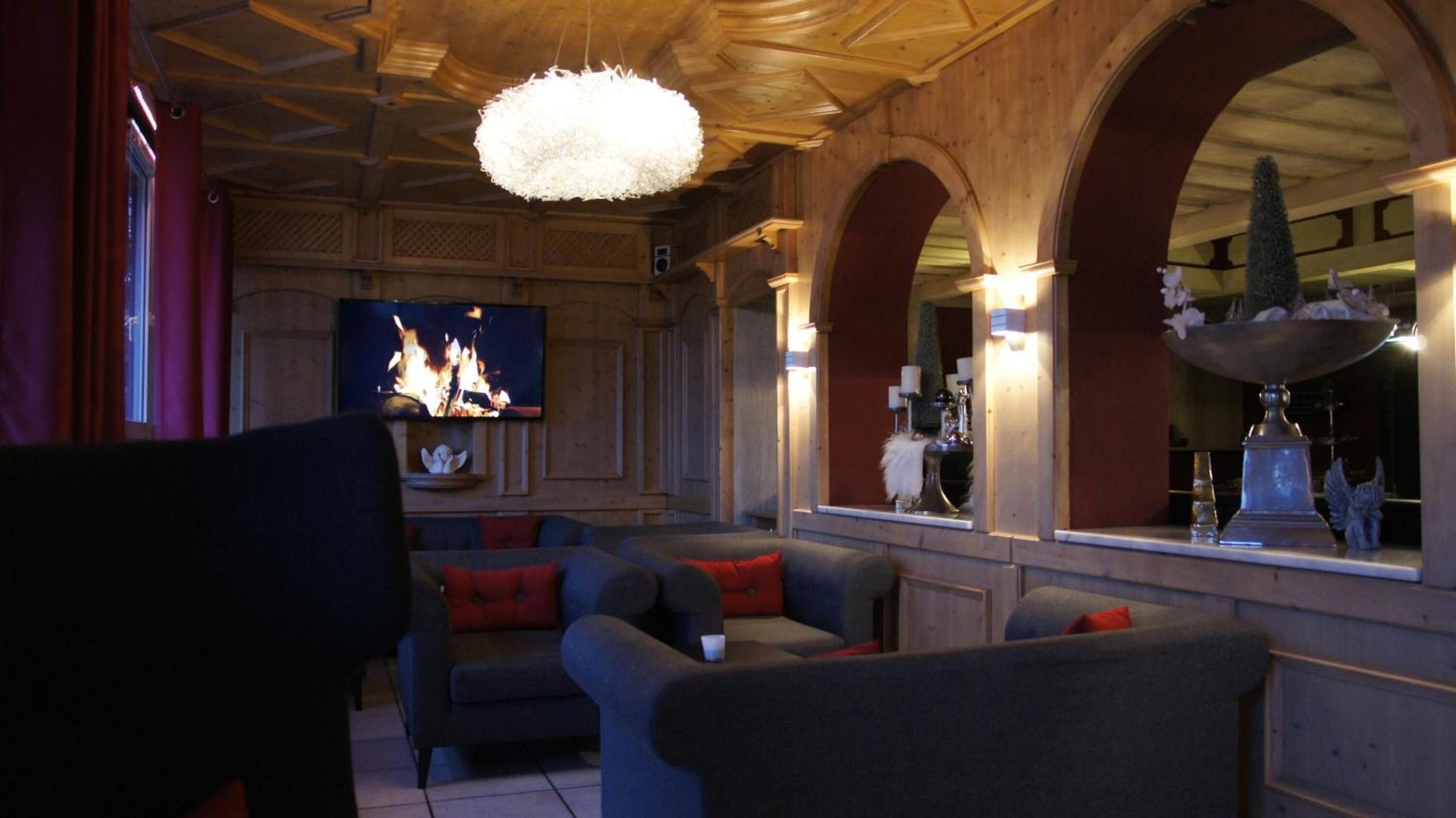 A cozy living room with a fireplace, comfortable seating, and a television.