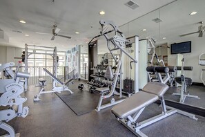 A gym with various exercise equipment, including weight machines and free weights. - Mosaic South End - 1402 (Charlotte)