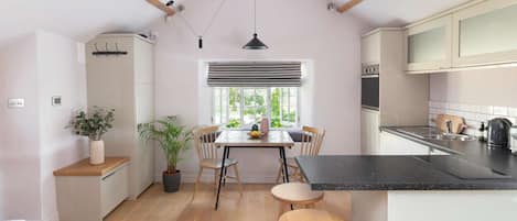 Enjoy a well-equipped kitchen and dining area with a kettle, toaster, and wooden table.