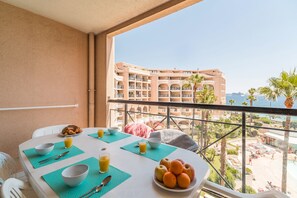 Enjoy a meal on the balcony with a view of the resort and beach.