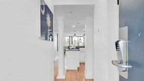 A modern kitchen with white cabinets, a central island, and a built-in oven. - 314 C Shipwatch by AvantStay | OCEANFRONT WITH OCEAN VIEW (Isle Of Palms)