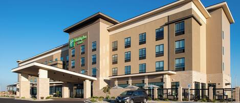 A Holiday Inn Express hotel with a modern design, featuring a covered entrance and multiple windows.
