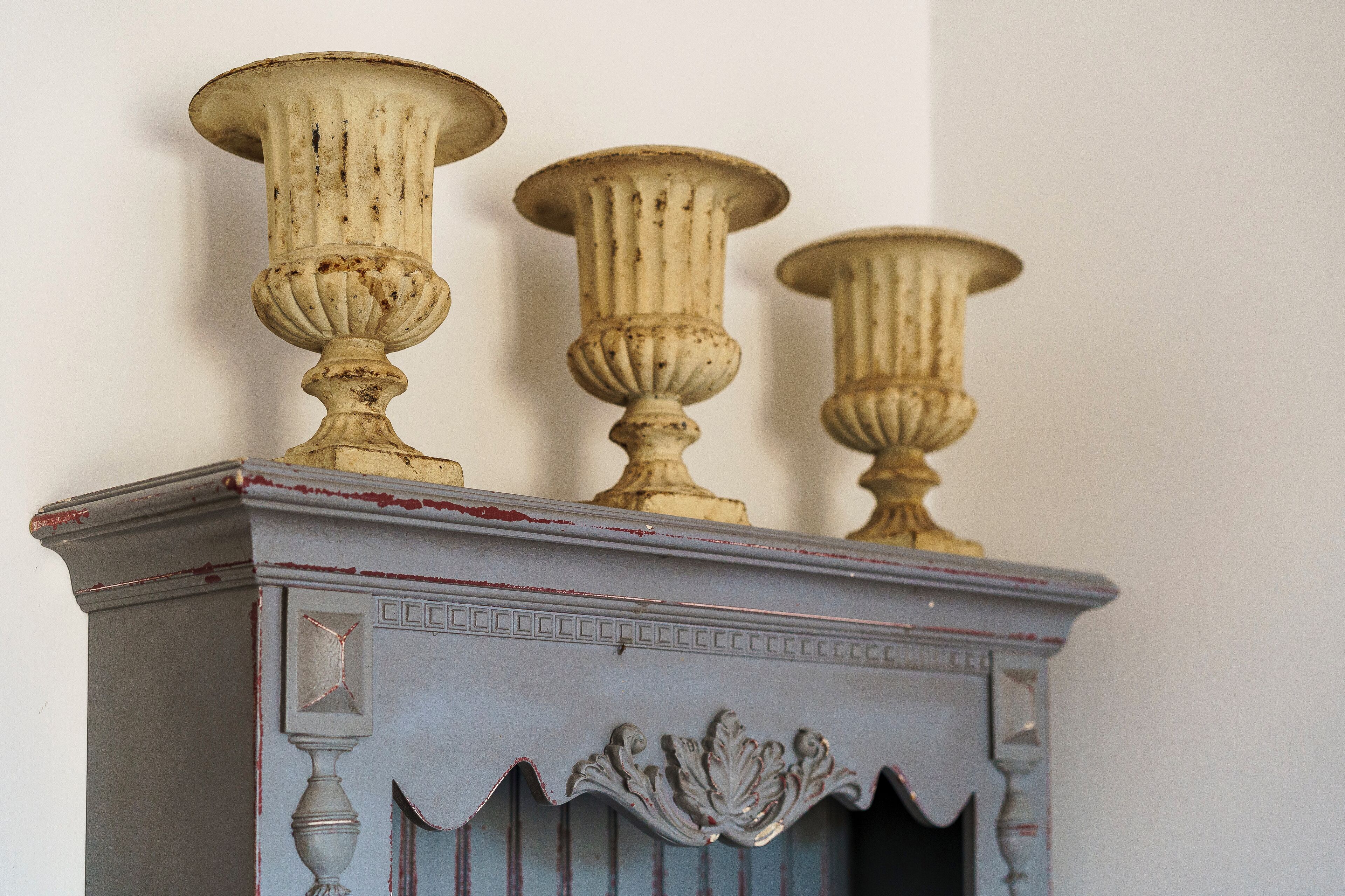 A piece of furniture with three ornate, column-like structures on top.