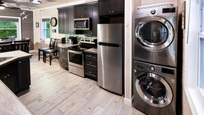 A modern kitchen with stainless steel appliances, a built-in oven, and a microwave. - Cozy Cove/Beach/FREE Golf Cart/Umbrella/Chairs/Kayak/Quiet Dead End Street (Spanish Wells)