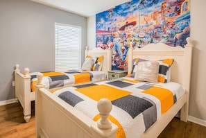 A bedroom with two beds, a large mural on the wall, and a window with blinds. - Family 4BR Pool  Near Disney (Kissimmee)