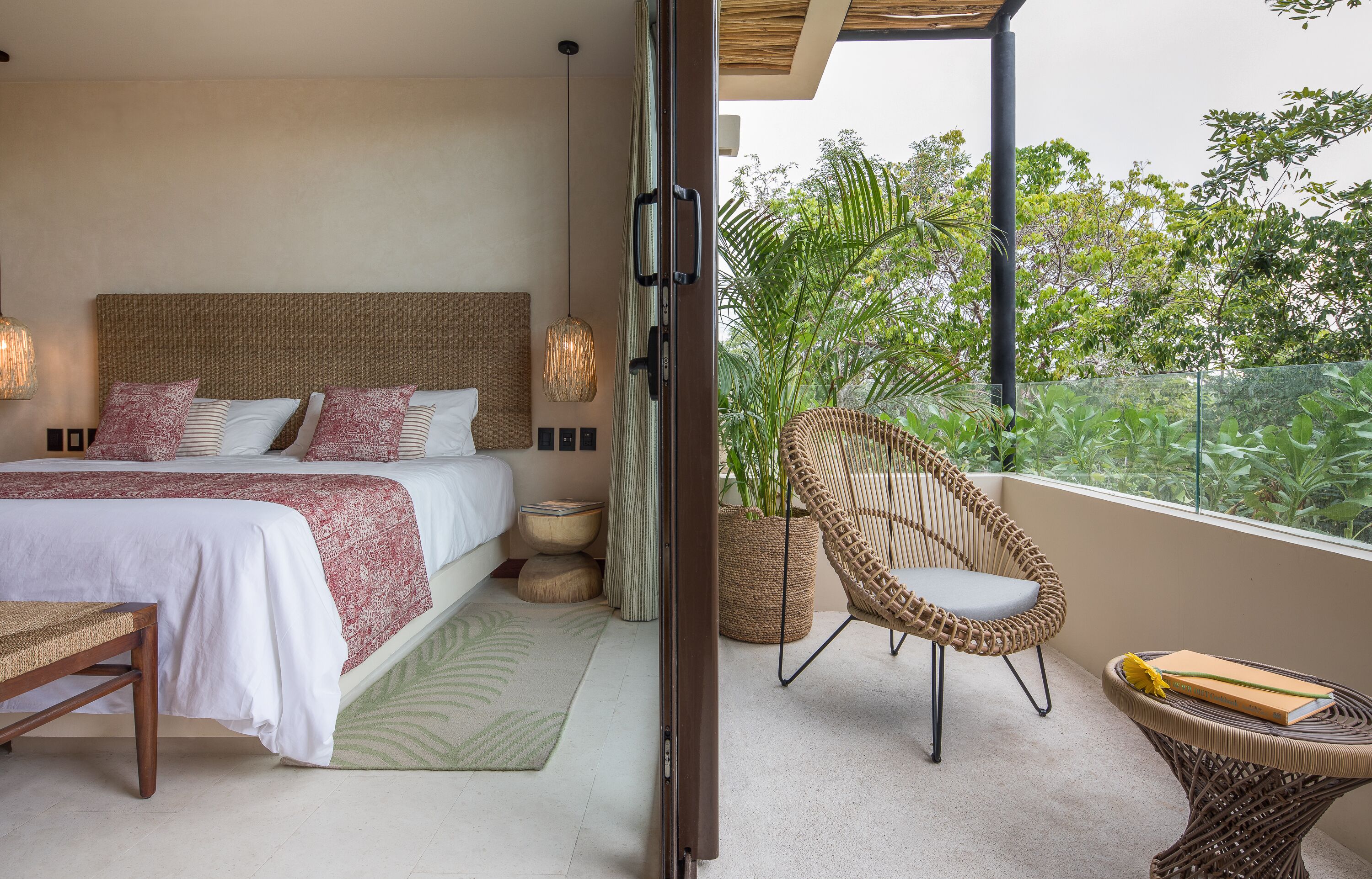 A bedroom with a large bed, bedside tables, a chair, and a small table.