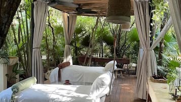 Relax under a serene wooden canopy, surrounded by lush greenery and a tranquil atmosphere.