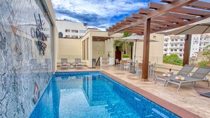 A swimming pool with lounge chairs and a pergola. - Casa Nicole Boutique Hotel (Puerto Vallarta)