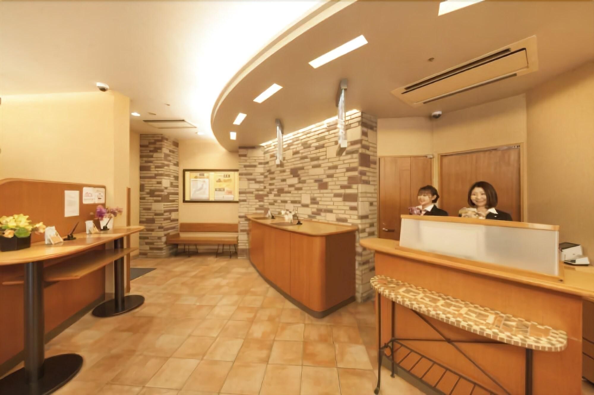 A reception area with a curved desk, a bench, and a tiled floor.