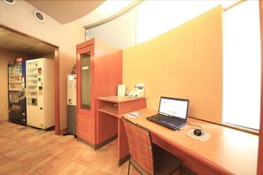 A small office space with a desk, a laptop, a computer mouse, a vending machine, and a filing cabinet. - R&B Morioka-ekimae (Morioka)