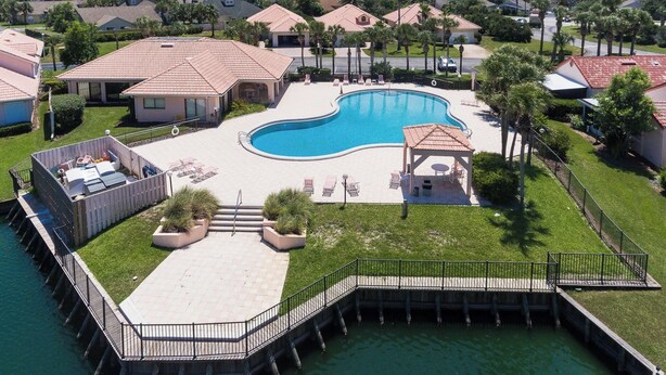 A residential area with a swimming pool, a dock, and a gazebo. - 2 Bed, 2 Bath, Ocean View, Poolside - Sea Place 13137 (St. Augustine)