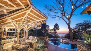 A poolside area with a bar, outdoor seating, and a view of the sunset over the water. - Oceanview Escape in Peninsula Papagayo – Pool, Concierge & Resort Access (Peninsula Papagayo)