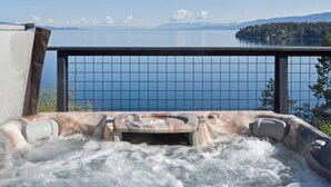 A hot tub with a view of a lake and mountains. - Modern Mountain Lake House - 3 bedrooms + Master Loft (Polson)