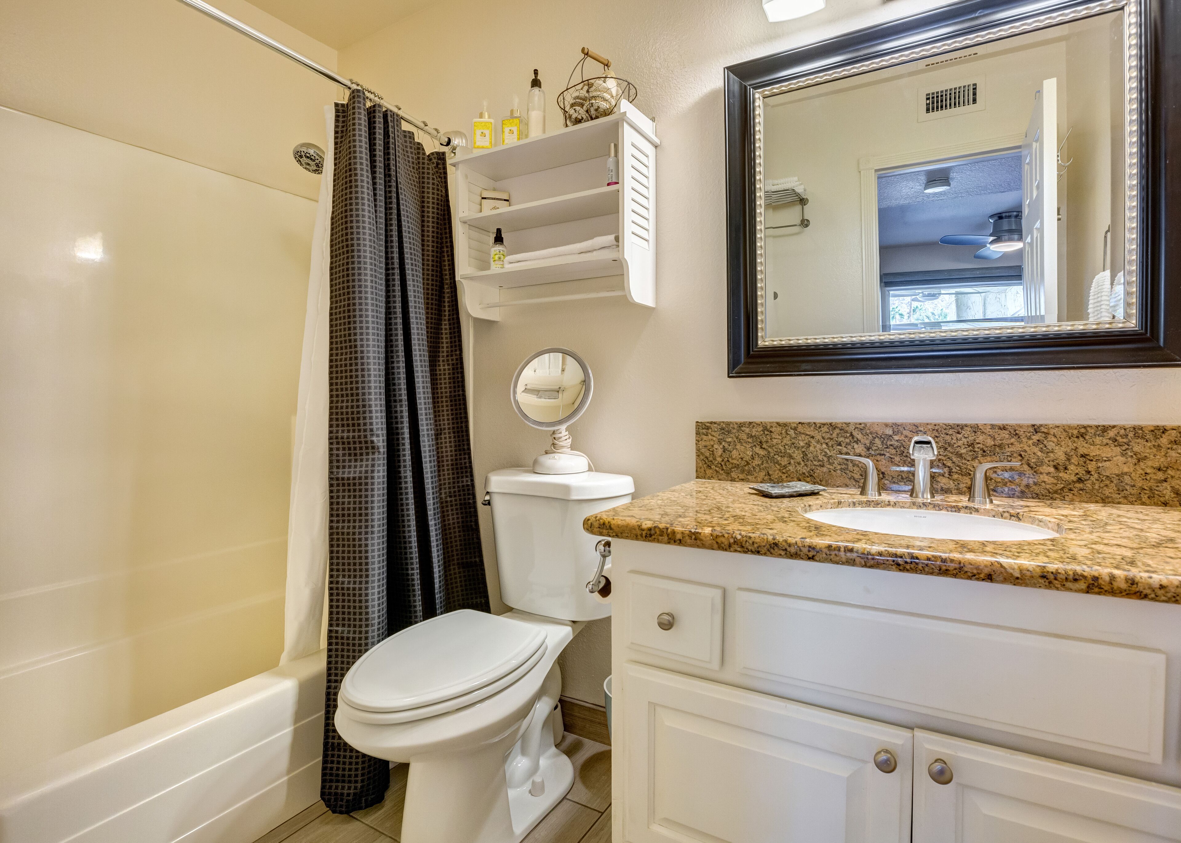 A bathroom with a toilet, sink, and shower.