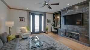 A modern living room with a sofa, coffee table, and a fireplace.