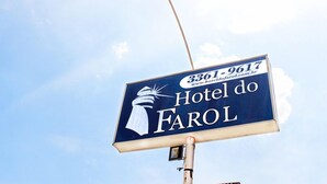 A hotel sign with the name "Hotel do Farol" and a phone number. - Hotel do Farol (Cubatao)