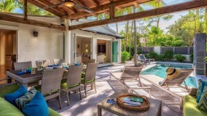 An outdoor patio with a dining table, chairs, and a pool area. - **MIDTOWN MOSAIC @ MIDTOWN** Home & Pool + Last Key White Glove Service... (Key West)