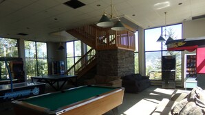 A pool table in a room with a staircase, a couch, and a vending machine. - Three House 2 Bed 2 Bath THWC (Silverthorne)