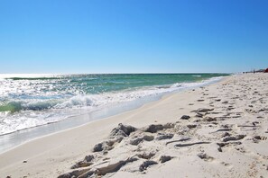 Enjoy a serene beach experience with calm ocean waters and a wide stretch of sand.