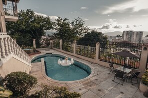 Outdoor pool, open 6:00 AM to midnight, pool umbrellas