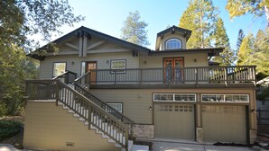 A two-story house with a front porch, a staircase, and a garage. - Lake Shore - Lake Front (Bass Lake)