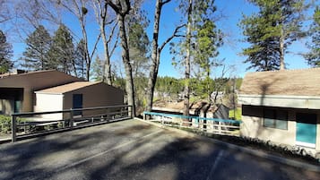 A residential area with houses, a paved road, and trees.