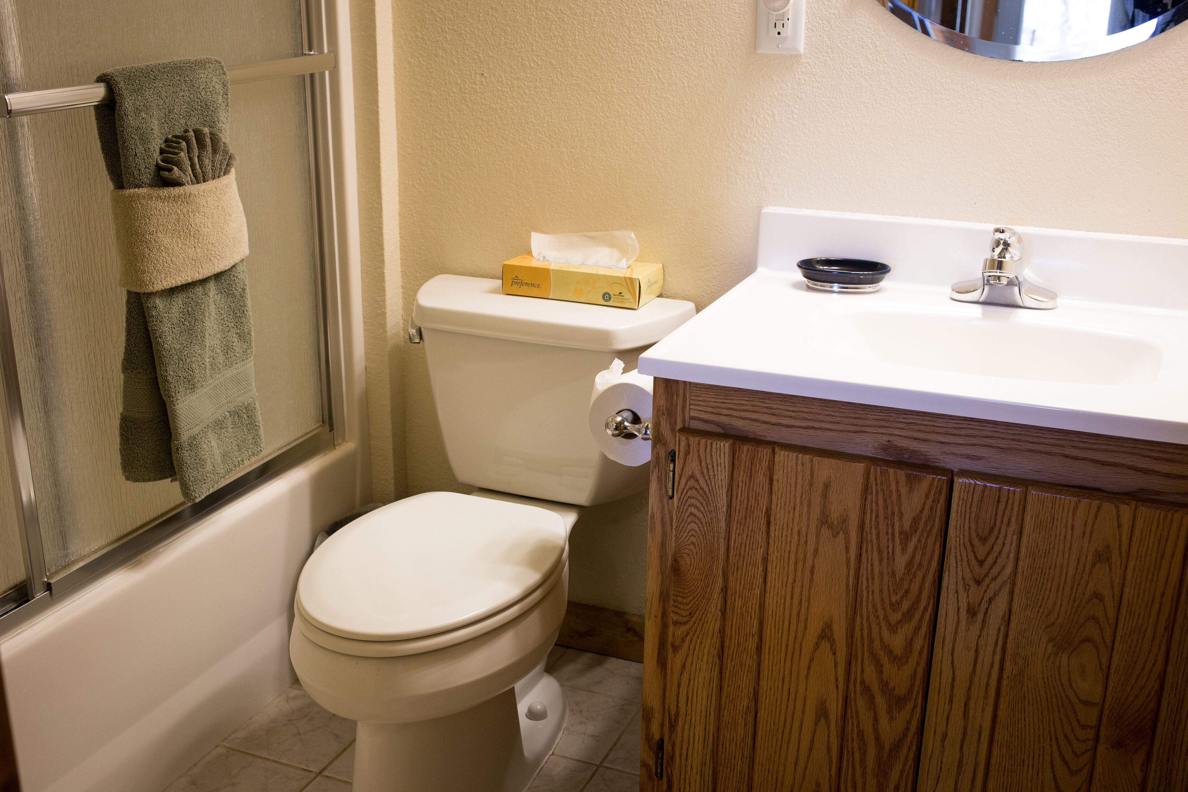 A bathroom with a toilet, a sink, and a towel rack.